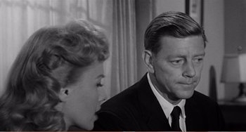 Movie still from “The Incredible Shrinking Man” (1957), directed by Jack Arnold – An older man and a younger woman sitting next to each other; Close Up shot, Over the shoulder angle