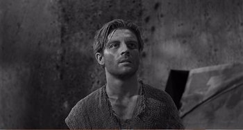 Movie still from “The Incredible Shrinking Man” (1957), directed by Jack Arnold – Black and white photograph of a young man looking at the camera; Close Up shot, Low angle