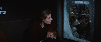 Movie still from “The Inn of the Sixth Happiness” (1958), directed by Mark Robson – A woman and a baby looking out a window at night; Close Up shot, Over the shoulder angle