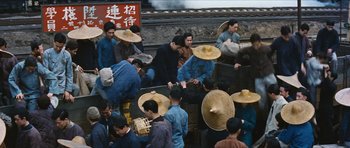 Movie still from “The Inn of the Sixth Happiness” (1958), directed by Mark Robson – A group of people with hats on their heads; Wide shot, High angle