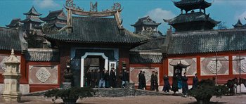 Movie still from “The Inn of the Sixth Happiness” (1958), directed by Mark Robson – A group of people standing in front of a building; Extreme Wide shot, Low angle