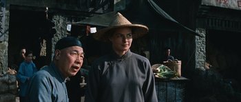 Movie still from “The Inn of the Sixth Happiness” (1958), directed by Mark Robson – A woman wearing a hat standing next to another woman; Medium shot, Over the shoulder angle