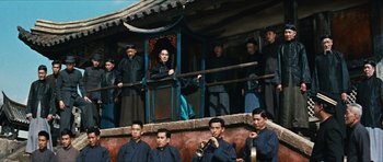 Movie still from “The Inn of the Sixth Happiness” (1958), directed by Mark Robson – A group of men standing next to each other on a balcony; Wide shot, Low angle