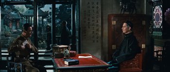 Movie still from “The Inn of the Sixth Happiness” (1958), directed by Mark Robson – A table in a room with a book on top of it; Wide shot, Over the shoulder angle