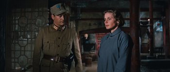 Movie still from “The Inn of the Sixth Happiness” (1958), directed by Mark Robson – A man and a woman standing next to each other in a room; Medium shot, Low angle