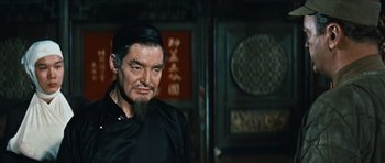 Movie still from “The Inn of the Sixth Happiness” (1958), directed by Mark Robson – An older man with a beard and a black hat; Close Up shot, Low angle