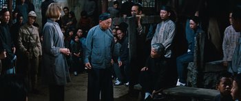 Movie still from “The Inn of the Sixth Happiness” (1958), directed by Mark Robson – An old man and a woman in front of an audience; Wide shot, Over the shoulder angle