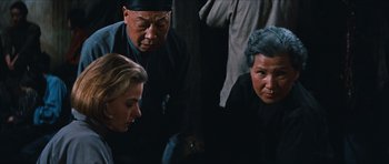 Movie still from “The Inn of the Sixth Happiness” (1958), directed by Mark Robson – A group of people standing next to each other in a room; Medium shot, Over the shoulder angle