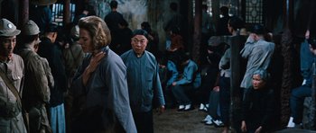 Movie still from “The Inn of the Sixth Happiness” (1958), directed by Mark Robson – A group of people sitting in a room; Medium shot, Over the shoulder angle