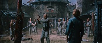 Movie still from “The Inn of the Sixth Happiness” (1958), directed by Mark Robson – A group of men in uniforms are standing in a field; Wide shot, Low angle