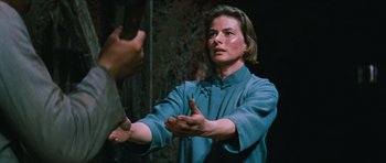 Movie still from “The Inn of the Sixth Happiness” (1958), directed by Mark Robson – A woman in a blue shirt is holding a knife; Close Up shot, Over the shoulder angle
