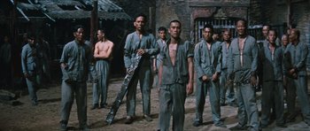 Movie still from “The Inn of the Sixth Happiness” (1958), directed by Mark Robson – A group of men standing next to each other; Wide shot, Low angle