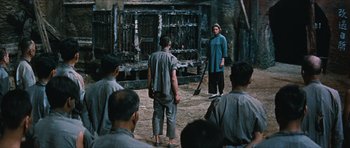 Movie still from “The Inn of the Sixth Happiness” (1958), directed by Mark Robson – A group of people standing around in front of a building; Wide shot, High angle