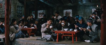 Movie still from “The Inn of the Sixth Happiness” (1958), directed by Mark Robson – A group of people sitting around a table with cups of tea; Wide shot, High angle