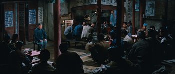 Movie still from “The Inn of the Sixth Happiness” (1958), directed by Mark Robson – A group of people sitting around in a room; Wide shot, High angle