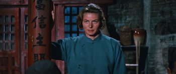 Movie still from “The Inn of the Sixth Happiness” (1958), directed by Mark Robson – A woman in a blue shirt is posing for a picture; Close Up shot, Over the shoulder angle