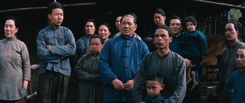 Movie still from “The Inn of the Sixth Happiness” (1958), directed by Mark Robson – A group of men and women standing in front of a building; Medium shot, Over the shoulder angle
