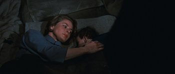 Movie still from “The Inn of the Sixth Happiness” (1958), directed by Mark Robson – A woman and a child laying on the ground; Close Up shot, High angle