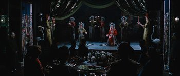 Movie still from “The Inn of the Sixth Happiness” (1958), directed by Mark Robson – A group of people performing a dance on a stage; Wide shot, High angle