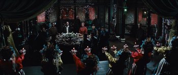 Movie still from “The Inn of the Sixth Happiness” (1958), directed by Mark Robson – A group of people standing around a table with candles on it; Wide shot, High angle