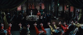 Movie still from “The Inn of the Sixth Happiness” (1958), directed by Mark Robson – A group of people sitting around a table with candles in their hands; Wide shot, High angle
