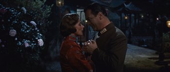 Movie still from “The Inn of the Sixth Happiness” (1958), directed by Mark Robson – A man and a woman are holding each other; Medium shot, Low angle