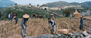 Movie still from “The Inn of the Sixth Happiness” (1958), directed by Mark Robson – A group of people working in a field; Wide shot, Low angle