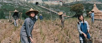 Movie still from “The Inn of the Sixth Happiness” (1958), directed by Mark Robson – A group of people working in a field; Medium shot, Over the shoulder angle