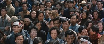 Movie still from “The Inn of the Sixth Happiness” (1958), directed by Mark Robson – A large group of people standing together in a crowd; Wide shot, High angle