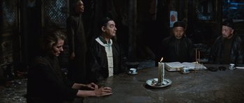 Movie still from “The Inn of the Sixth Happiness” (1958), directed by Mark Robson – A man sitting at a table with a lit candle; Medium shot, High angle