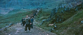 Movie still from “The Inn of the Sixth Happiness” (1958), directed by Mark Robson – A large group of people walking up a hill; Wide shot, High angle
