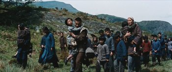 Movie still from “The Inn of the Sixth Happiness” (1958), directed by Mark Robson – A group of people walking in the grass; Wide shot, Low angle