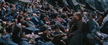 Movie still from “The Inn of the Sixth Happiness” (1958), directed by Mark Robson – A large group of people sitting on the ground; Wide shot, High angle