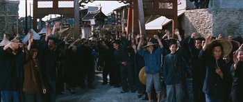 Movie still from “The Inn of the Sixth Happiness” (1958), directed by Mark Robson – A group of people standing next to each other on a street; Wide shot, High angle