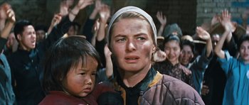 Movie still from “The Inn of the Sixth Happiness” (1958), directed by Mark Robson – An older woman and a young boy in front of a group of people; Close Up shot, Low angle