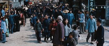 Movie still from “The Inn of the Sixth Happiness” (1958), directed by Mark Robson – A group of people walking down a street; Wide shot, High angle