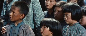 Movie still from “The Inn of the Sixth Happiness” (1958), directed by Mark Robson – A group of people standing next to each other on the street; Close Up shot, High angle