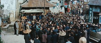 Movie still from “The Inn of the Sixth Happiness” (1958), directed by Mark Robson – A crowd of people standing in the middle of a street; Extreme Wide shot, High angle