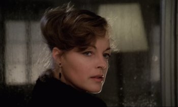 Movie still from “The Grilling” (1981), directed by Claude Miller – A person wearing a black shirt; Close Up shot, Low angle