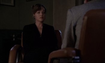 Movie still from “The Grilling” (1981), directed by Claude Miller – A woman sitting in a chair in front of a man; Medium shot, Over the shoulder angle