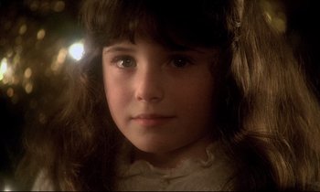 Movie still from “The Grilling” (1981), directed by Claude Miller – A young girl's face in a dark room; Close Up shot, High angle