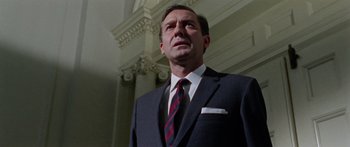 Movie still from “The Ipcress File” (1965), directed by Sidney J. Furie – A man in a suit and a tie; Close Up shot, Low angle