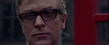 Movie still from “The Ipcress File” (1965), directed by Sidney J. Furie – A person wearing a pair of glasses; Close Up shot, Low angle