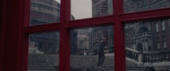 Movie still from “The Ipcress File” (1965), directed by Sidney J. Furie – A man walking down steps in front of a building; Extreme Wide shot, High angle
