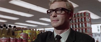 Movie still from “The Ipcress File” (1965), directed by Sidney J. Furie – A person wearing glasses and a suit; Close Up shot, Low angle