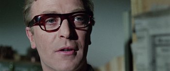 Movie still from “The Ipcress File” (1965), directed by Sidney J. Furie – A person wearing glasses; Close Up shot, Low angle