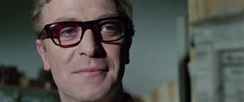 Movie still from “The Ipcress File” (1965), directed by Sidney J. Furie – A person wearing glasses; Close Up shot, Low angle