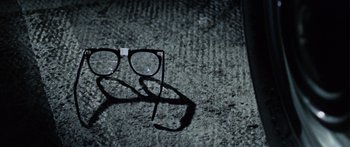 Movie still from “The Ipcress File” (1965), directed by Sidney J. Furie – A pair of eye glasses sitting on the ground; Extreme Close Up shot, Overhead angle