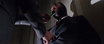 Movie still from “The Ipcress File” (1965), directed by Sidney J. Furie – A man in a business suit is brushing his teeth; Close Up shot, Low angle