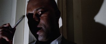 Movie still from “The Ipcress File” (1965), directed by Sidney J. Furie – A man's face in the dark; Close Up shot, Low angle